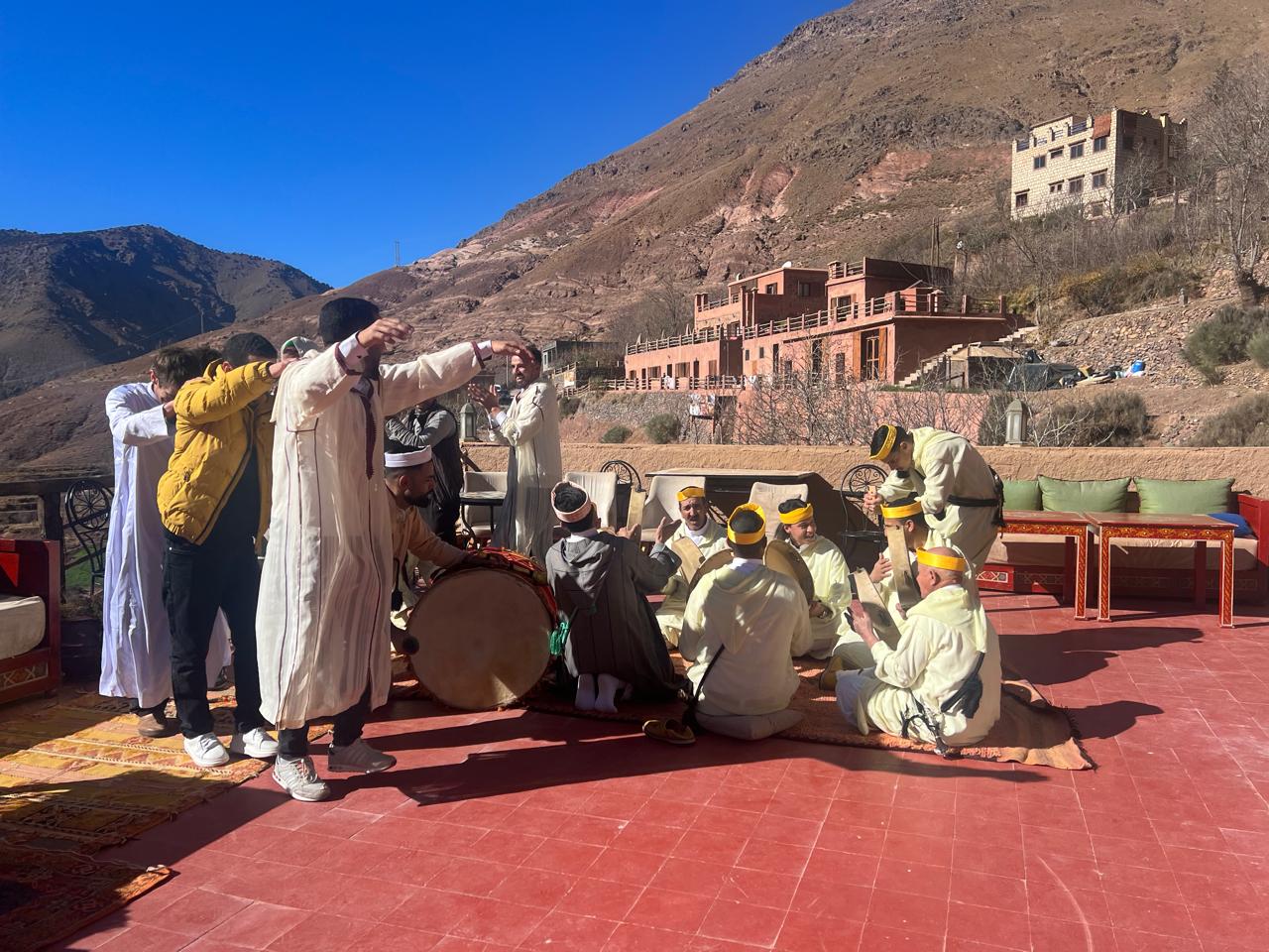 Guests and musicians gathering on a mountain terrace in Imlil