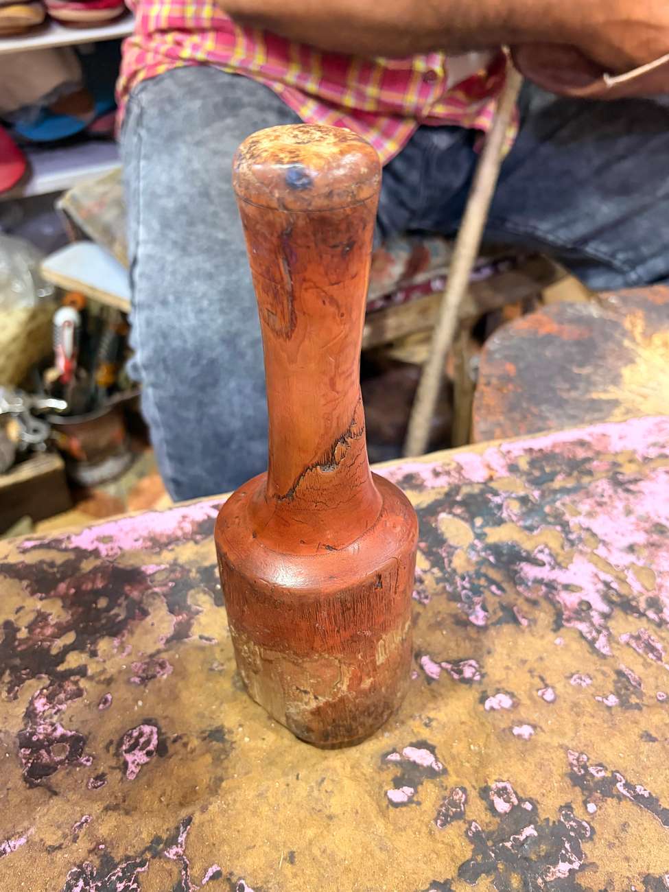A traditional wooden mallet used to shape the leather