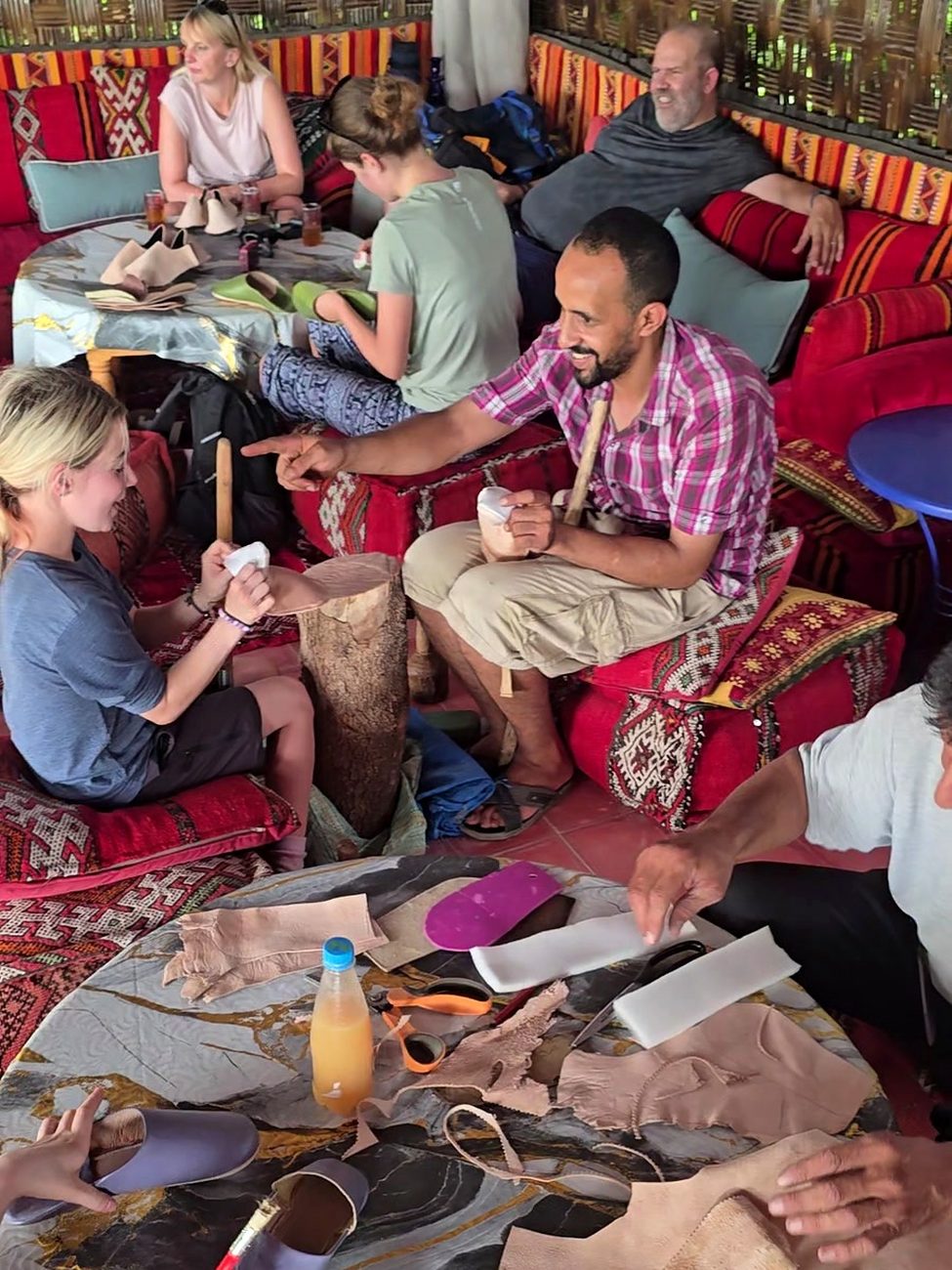 Guests making their own babouches with a leather craftsman at the workshop