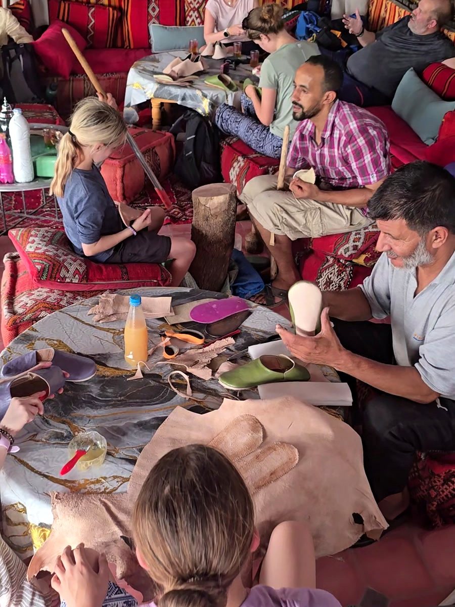 A craftsman fitting the sole of a babouche at the workshop table