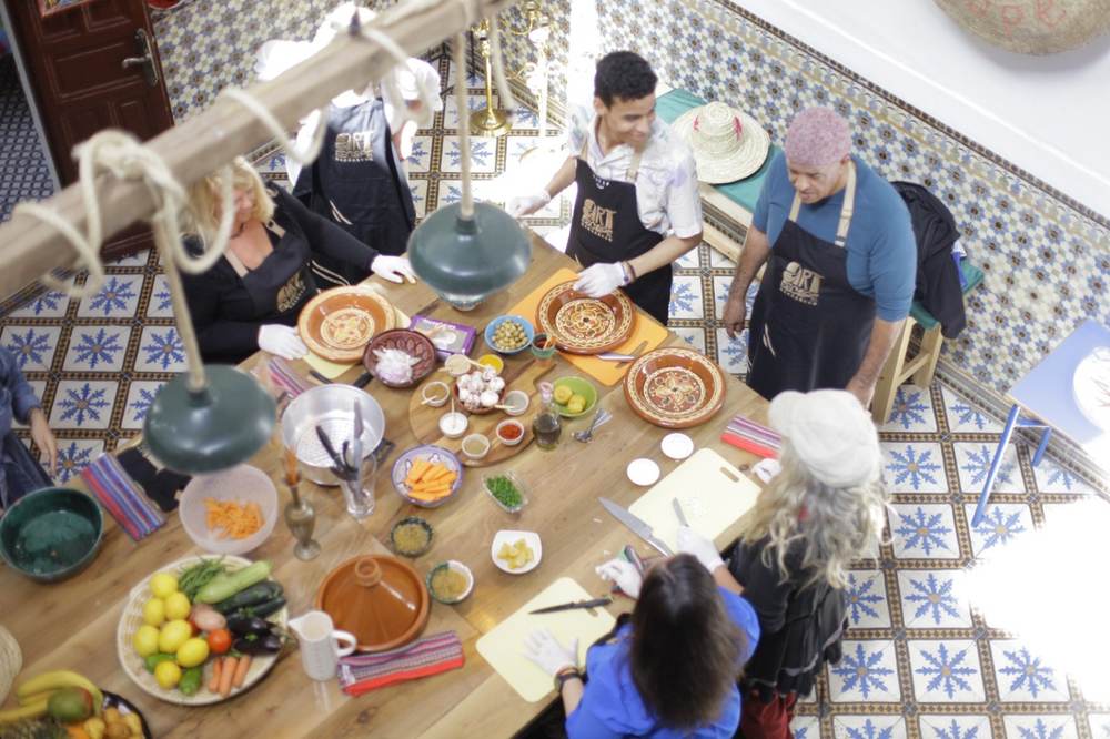 Guests preparing Moroccan dishes together